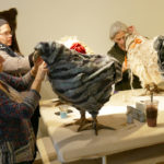 Women work on chicken footstools