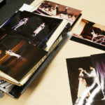 Stacks of photos of Devon performing in Romeo & Juliet are smattered across his desk.