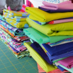 Stacks of fabric wait to be used in Tula Pink's studio.