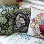 Three of Tula Pink's needlepoint pillows, which were once available as kits.