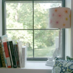 A cozy nook in Tula Pink's studio features inspirational books on William Morris