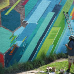 Phil Shafer debates on what colors to add to his mural in downtown Kansas City.