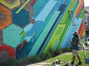 Phil Shafer debates on what colors to add to his mural in downtown Kansas City.