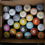 A rainbow of spray paint in Phil Shafer's studio.