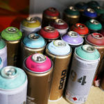 The tools of the trade: a shelf of spray paint in Phil Shafer's studio.