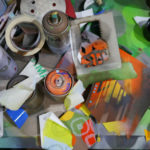 Work table full of spray paint, hexagons and stencils in Phil Shafer's studio.