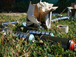 Empty spray paint cans litter the yard as Phil Shafer finishes his mural in downtown Kansas City.