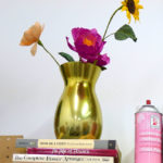 A stack of inspirational books topped with a paper floral bouquet in Grace D. Chin's studio.