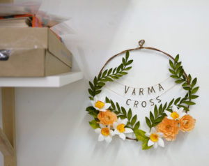 A floral wreath that features local band Varma Cross.