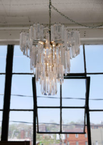 The chandelier that Evie turns on to symbolize that it is time to work.