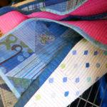 Glimpses of patchwork and stitching on one of Luke's quilts.