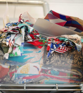 Tubs of fabric surround you in Luke's studio.