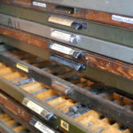 Drawers filled with different typefaces awaiting their turn in a letterpress design.