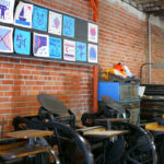 A gallery of Lego letterpress prints hang on the wall of the Two Tone Press studio.