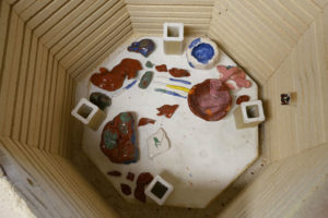 Ceramic pieces from Momoko's community class are fired in her kiln room.